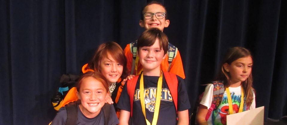 students smiling with awards