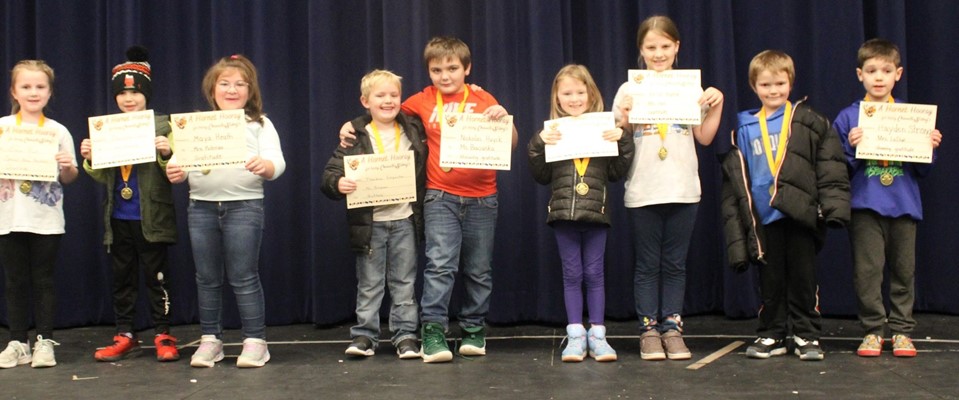 character strong award recipients lined up on stage with certificates