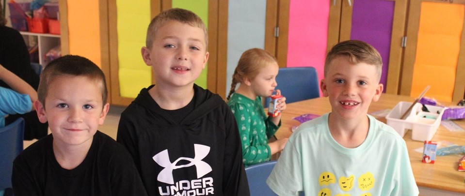 Welcome back photo of three boys