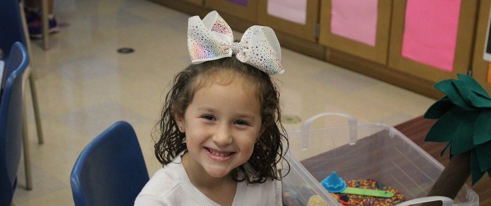 First day of school elementary student with cute hair bow