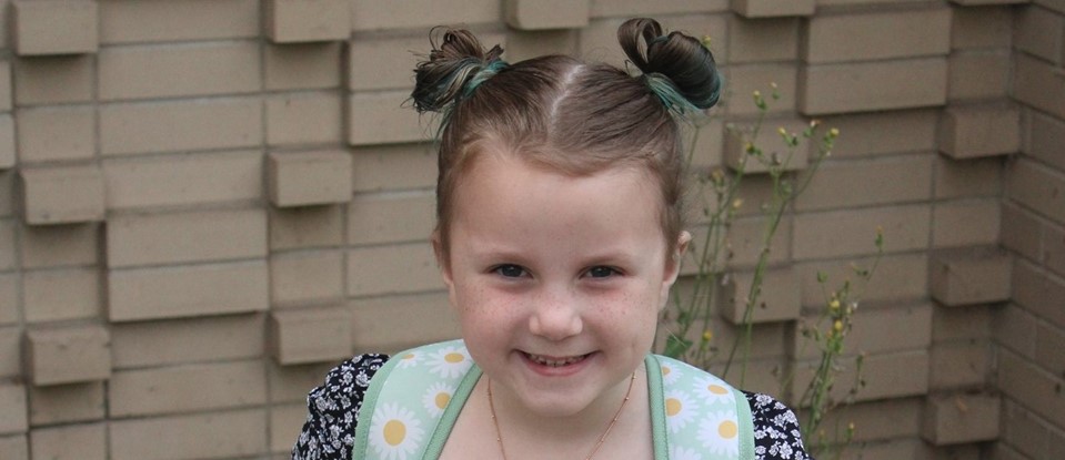 little girl in pigtails ready for her first day
