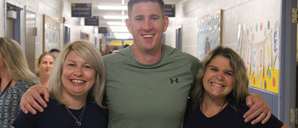Three staff members smiling on day one