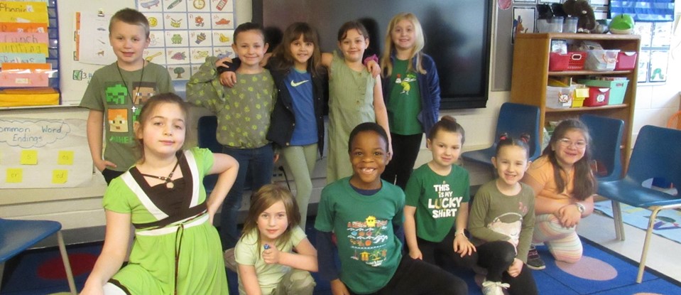 students dressed in green