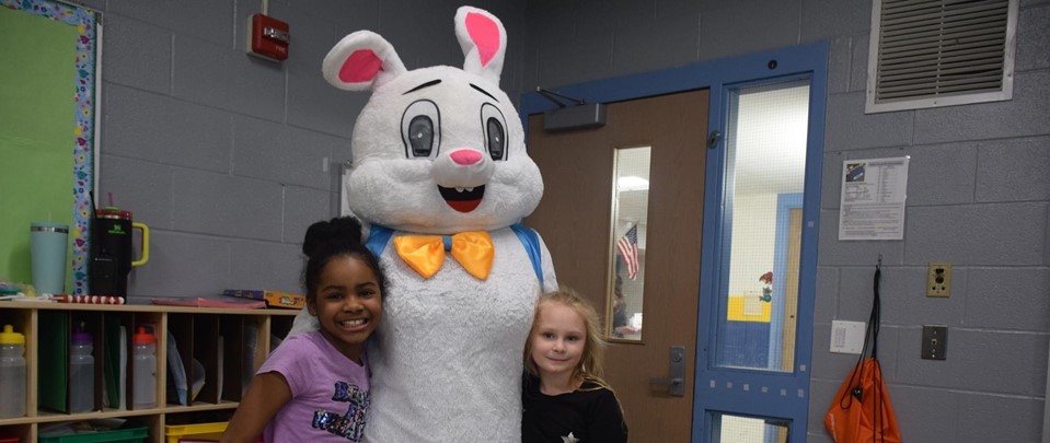 Easter bunny with two children smiling