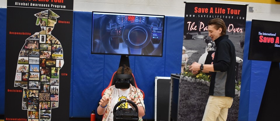 student sitting in a save a life tour simulator