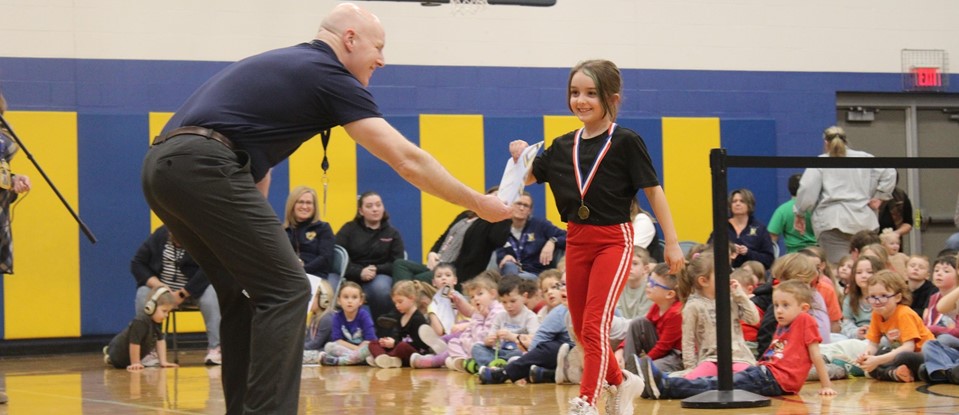 Principal Walsh shaking the hand of Cooperation award recipient