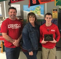 Parents standing with student